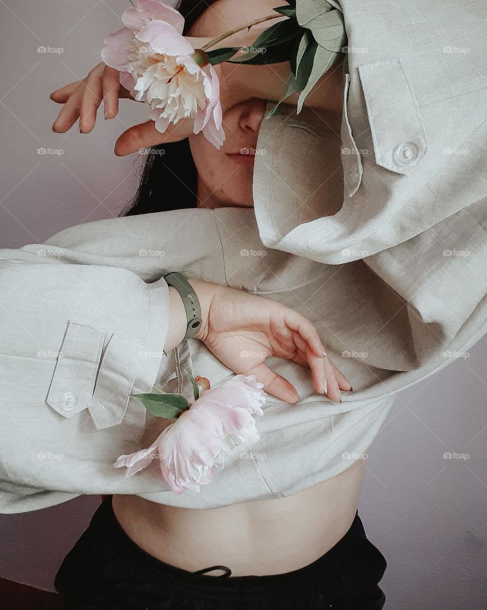 A white sweater on a girl with peonies