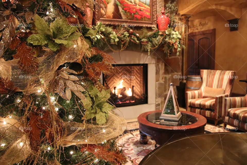 Beautiful Christmas tree in living room with fireplace