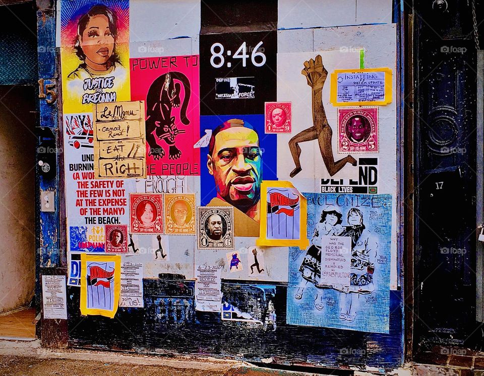 An artfully put together wall with various posters, flyers and announcements of events on a plaza on Fulton St in Fort Greene, Brooklyn, NY photographed in the summer of 2020. Hypnotic Productions