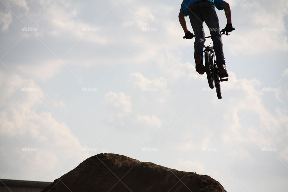 Low angle view of a person doing stunt on bicycle