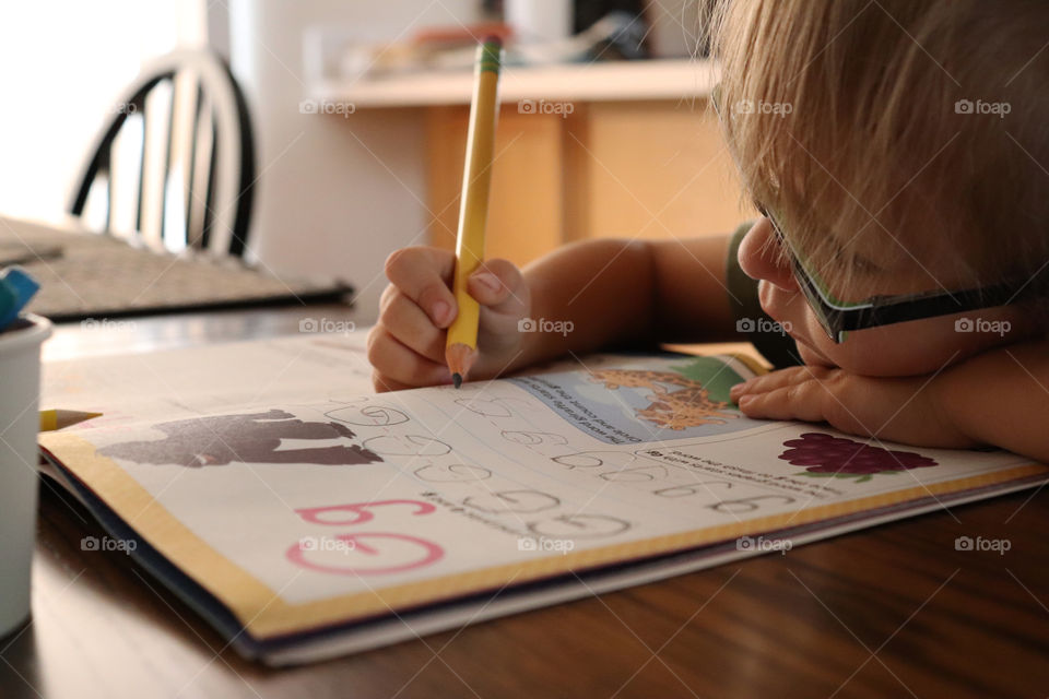 A child practicing her letters