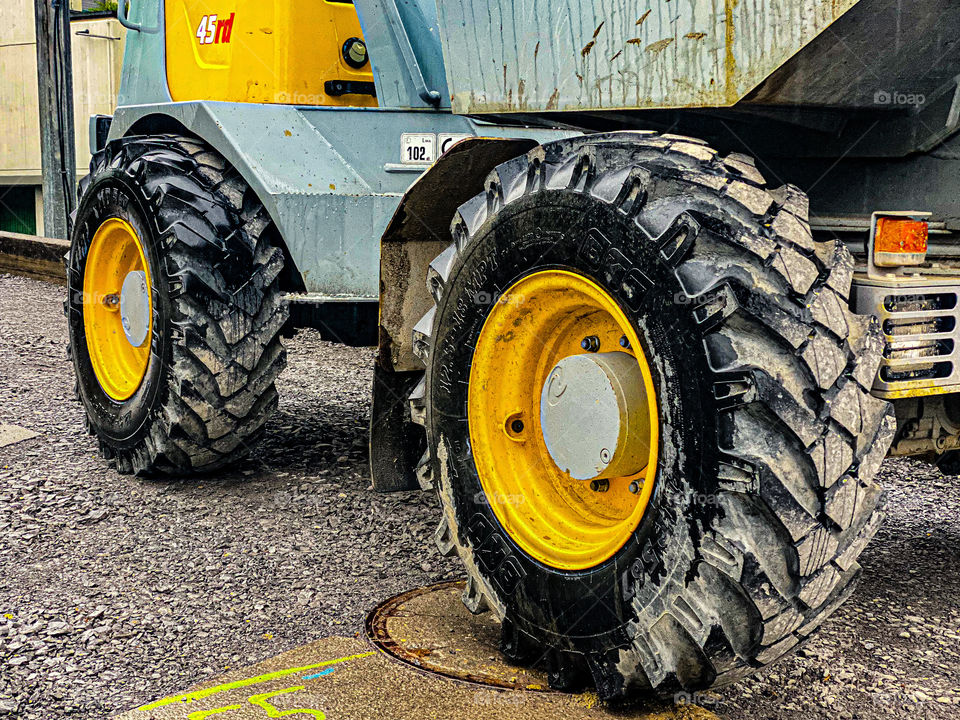 yellow concrete mixer with large round wheels