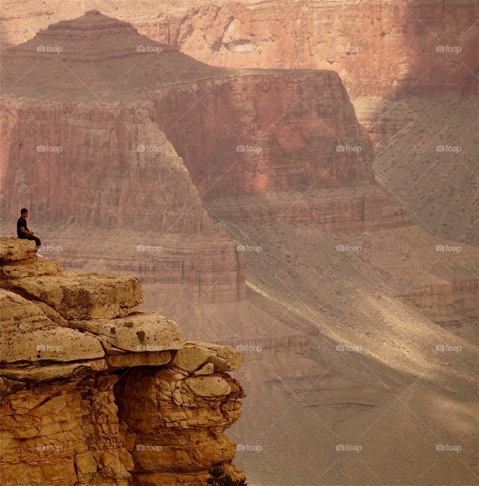 A person sitting on the rocky mountains