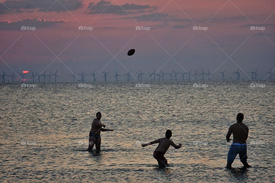 Playing in the water in sunset