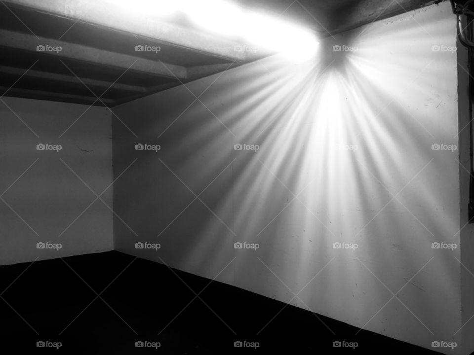 Faulty light at the far end of the ground floor of the NCP London Bridge car park, Kipling Street, Southwark. In Winter.