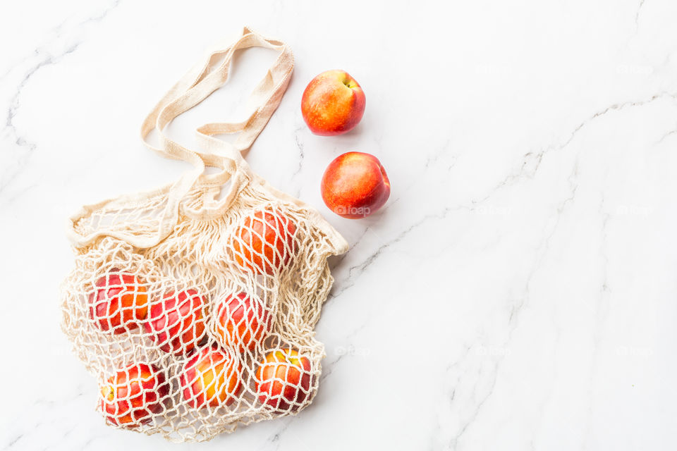 Fresh nectarines lying on marble background 