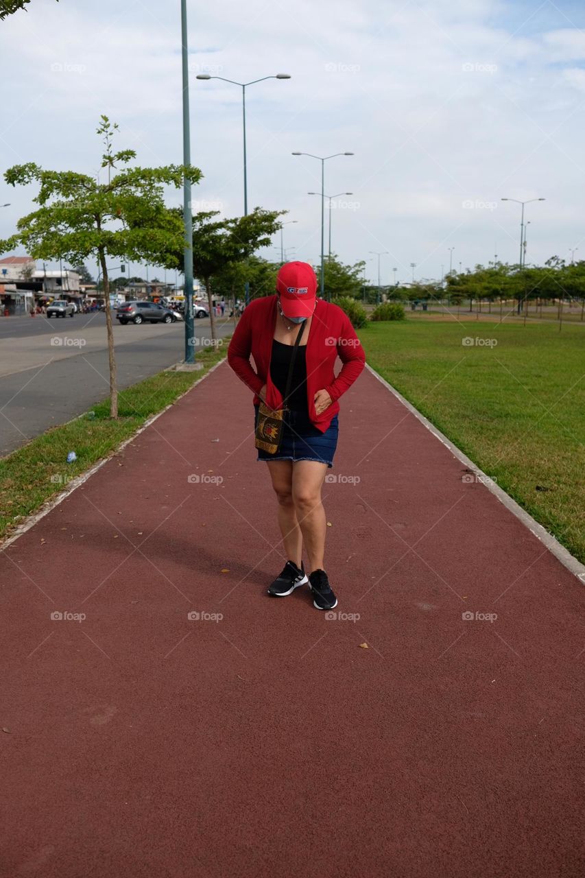 Tired woman running track fulfilling her health exercise regimen