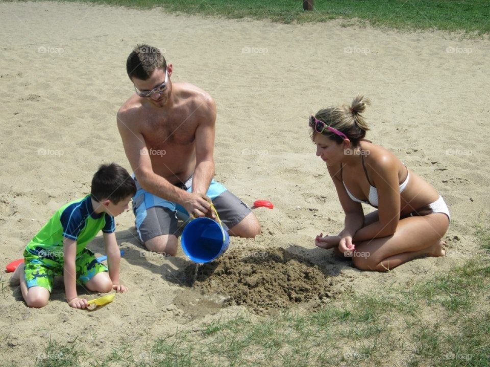 Family building a sand castle 