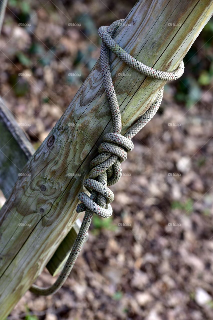 Rope tied up on wooden post