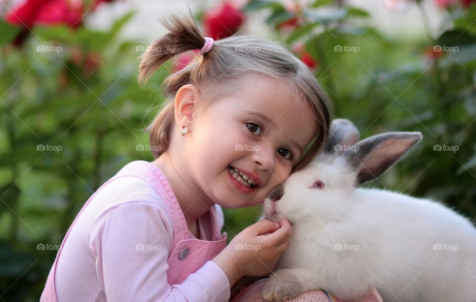 Smiling girl with white rabbit
