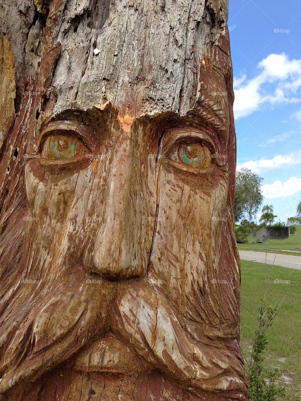Wooden carving of a man’s face.