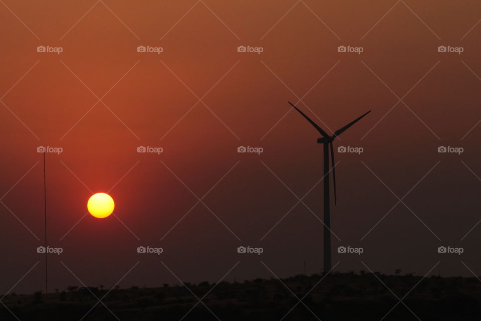 sunset behind windmill