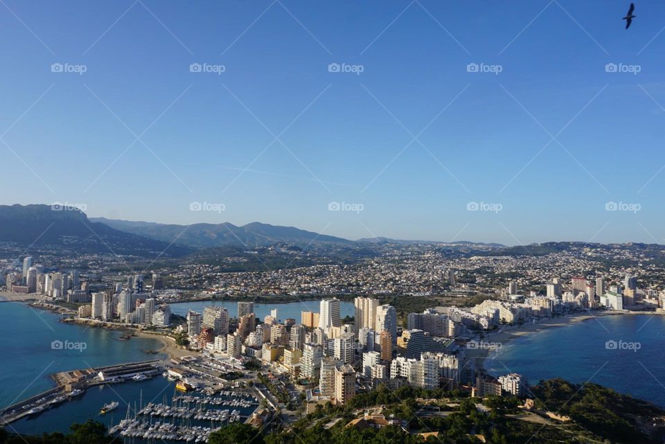 City#view#port#sea#buildings#boats#mountains