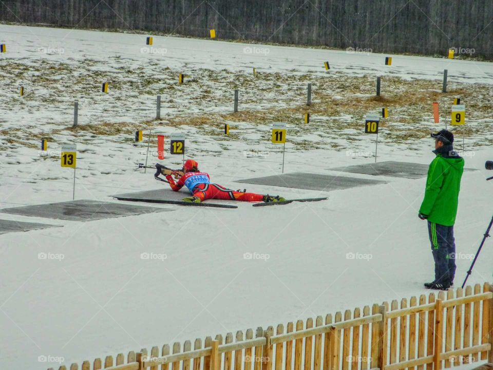 Biathlon Training, biathlet and Trainer.  watching him