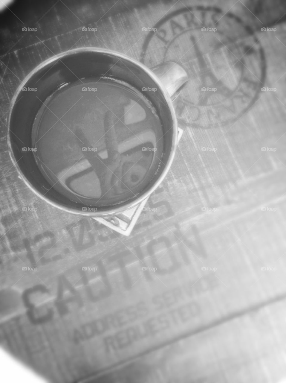 Peace and Coffee. Black & white photo depicting reflection in coffee of hand giving peace sign