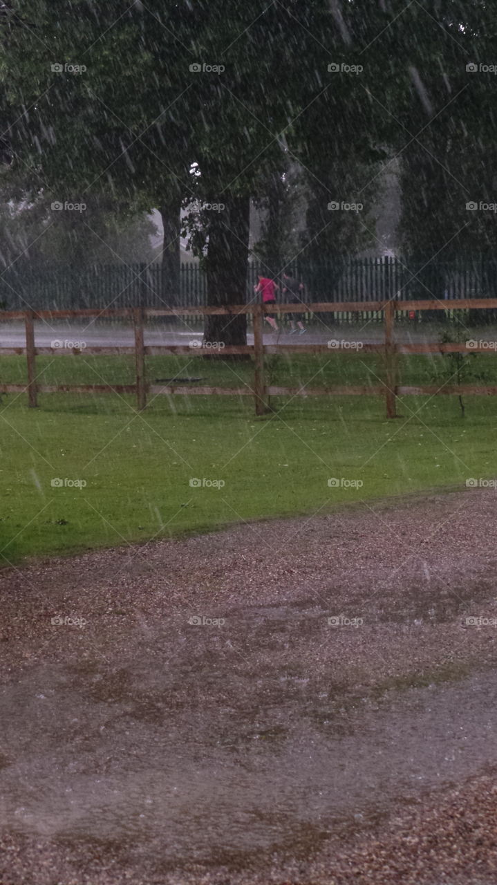 joggers in the heavy rain