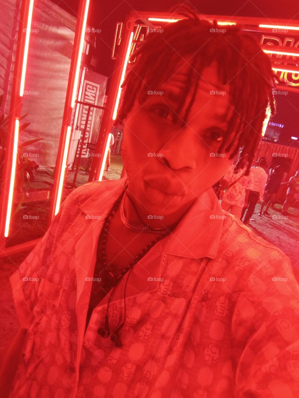 photo of a young guy on a red designed clothe