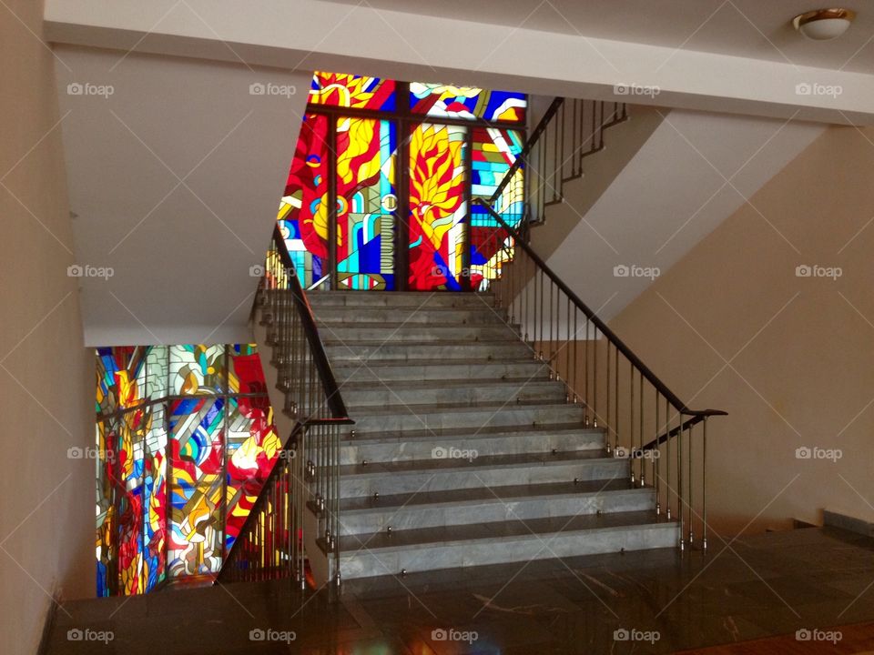 Staircase in an old soviet hotel with a big stained glass window