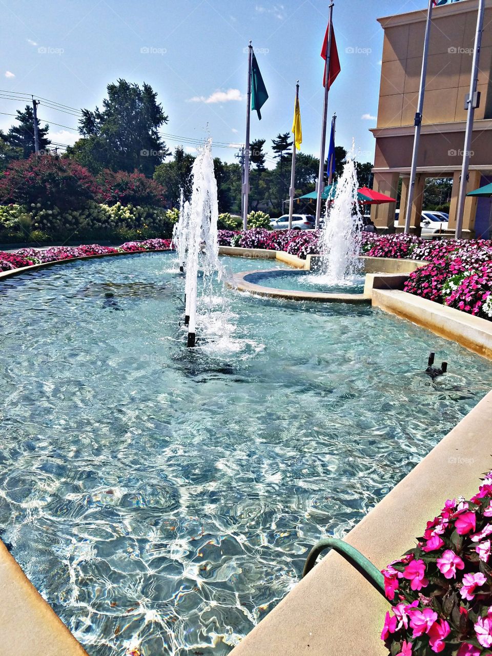 Carle Place, NY - August 2017 - Taken on Android Phone - Galaxy S7 - Outdoor Decorations: Water Fountains and Flowers on a Sunny Day