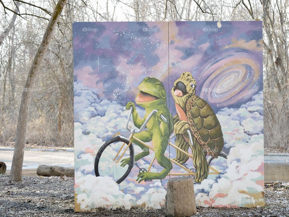 A look through a tunnel on the playground, gives a view of a full illustration of Frog and Turtle. 