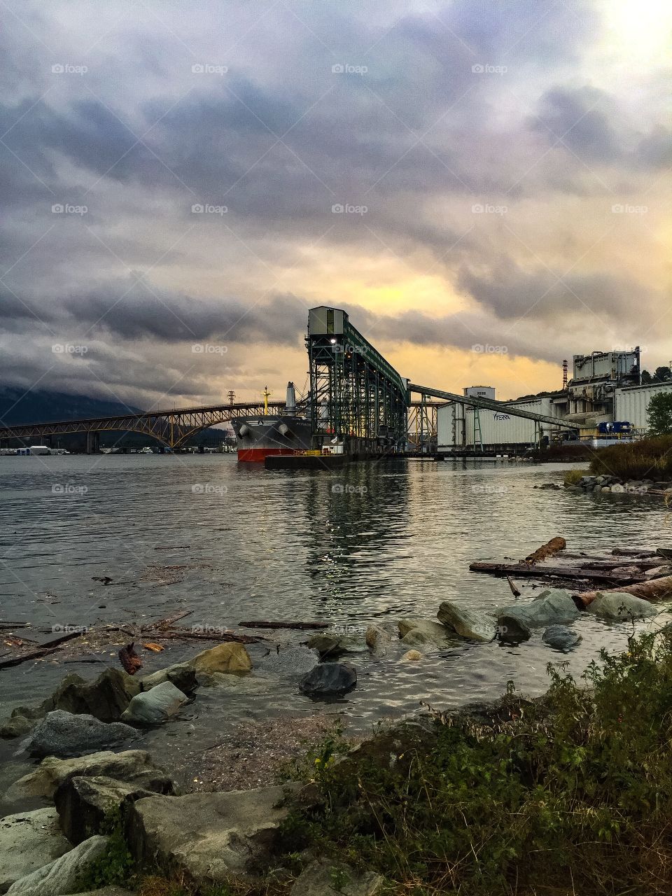 Eastern view of the Burrard inlet from Brighton Park in a rainy day in Vancouver, British Columbia 