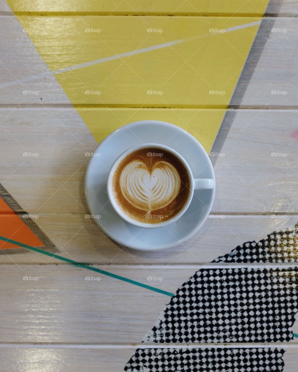 Cappuccino on a colorful table. 