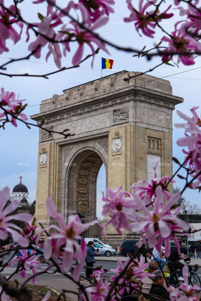 romanian arc de triomphe surrounded by flowers