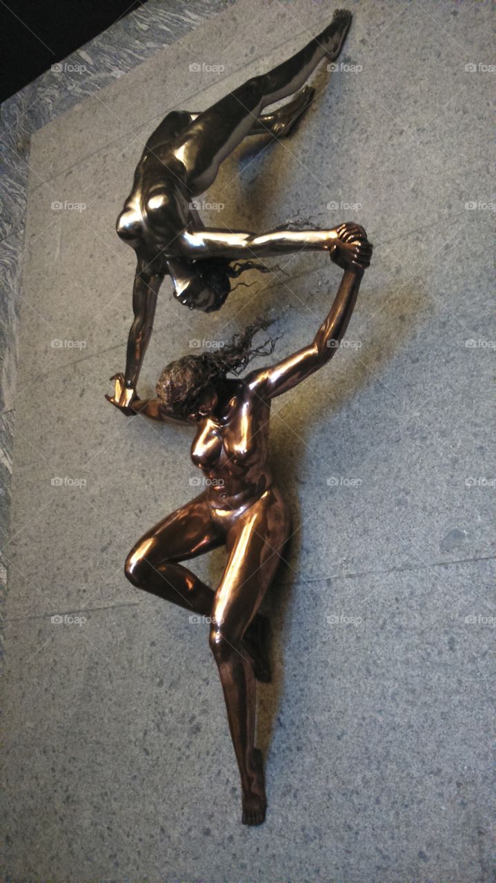 woman on woman. sculpture of maybe acrobatic women
