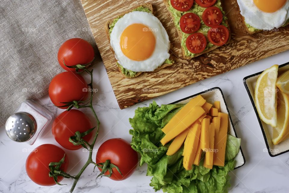 toast with avocado and scrambled eggs for breakfast