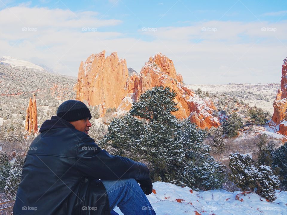 Hiker enjoys an expansive scene in the mountains. 