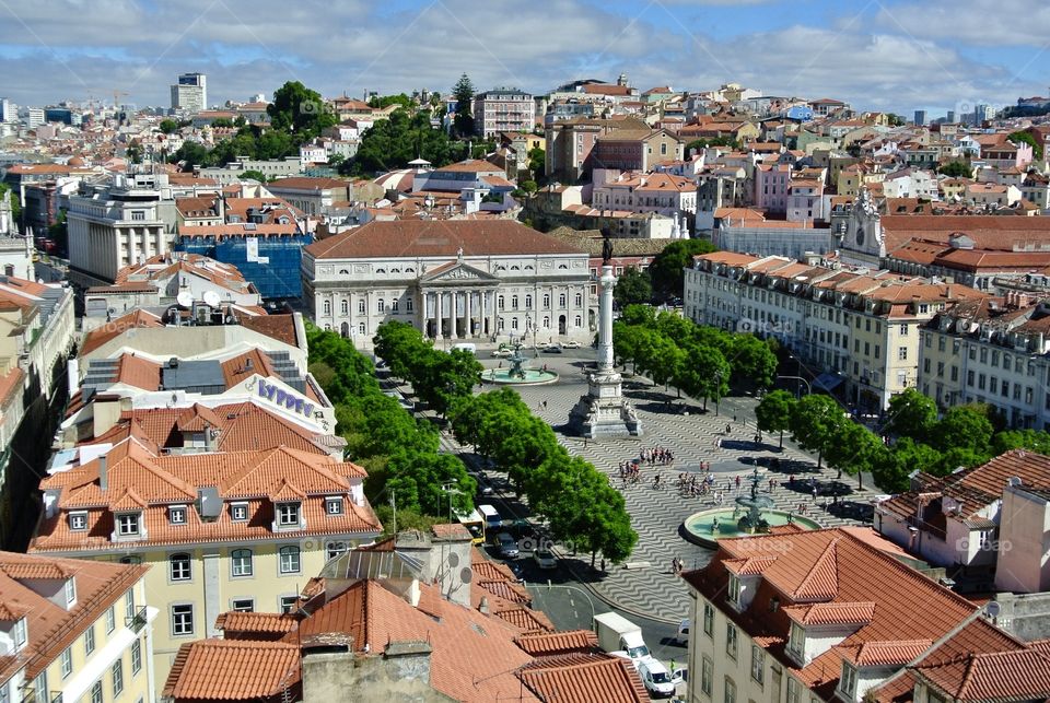 The charming city of Lisbon is one of the most colorful capitals one will find. Here is a view of Praca do Rossio and Teatro Nacional D. Maria II from Elevador de Santa Justa. #Lisbon #Portugal