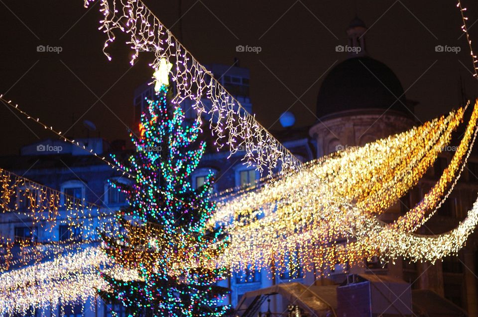 Low angle view of illuminated christmas decorations at night