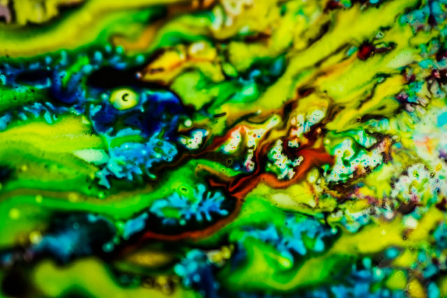 The ink to refill the printer cartridge was spilled onto the white washbasin and the paints blended into abstract drips and patterns.