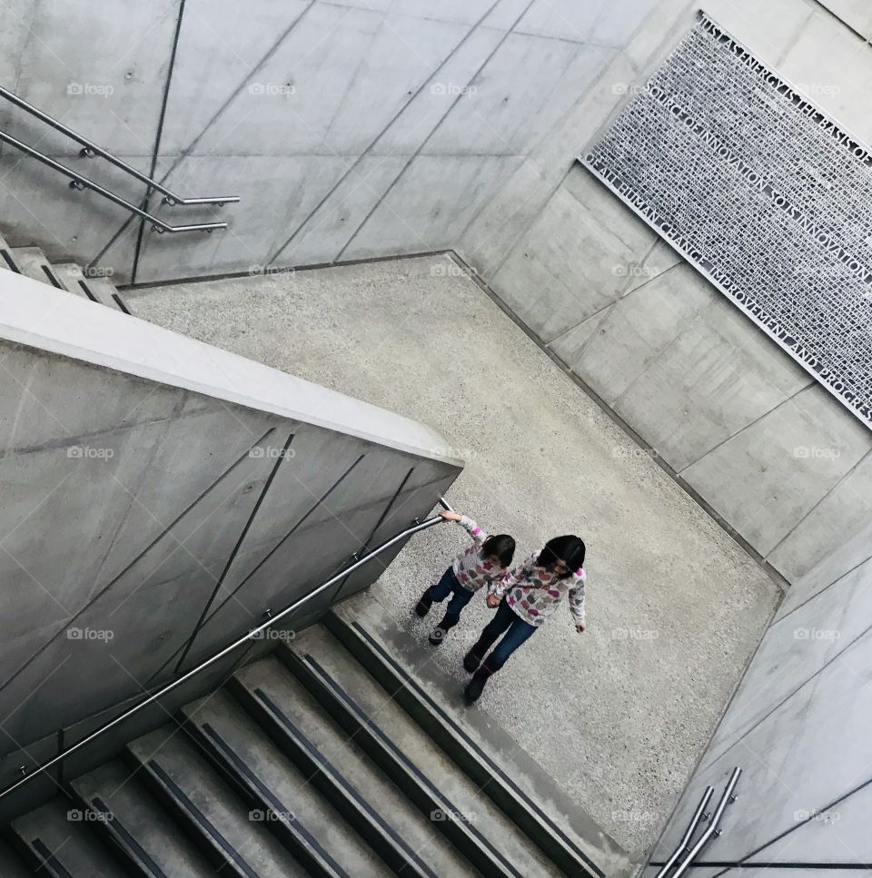 Kids in concrete building stairs