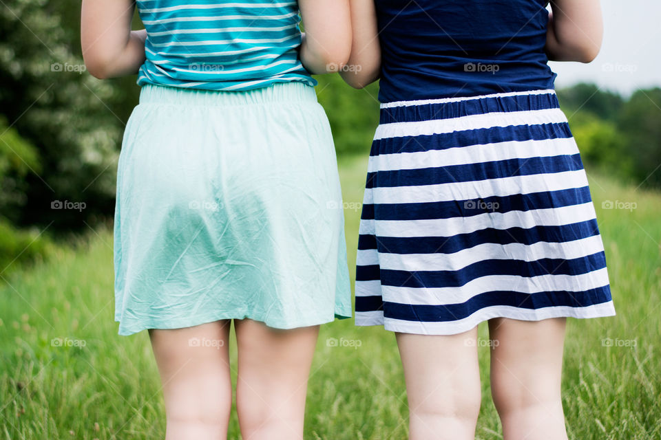 two girls in skirts. two girls in short skirts enjoying summer