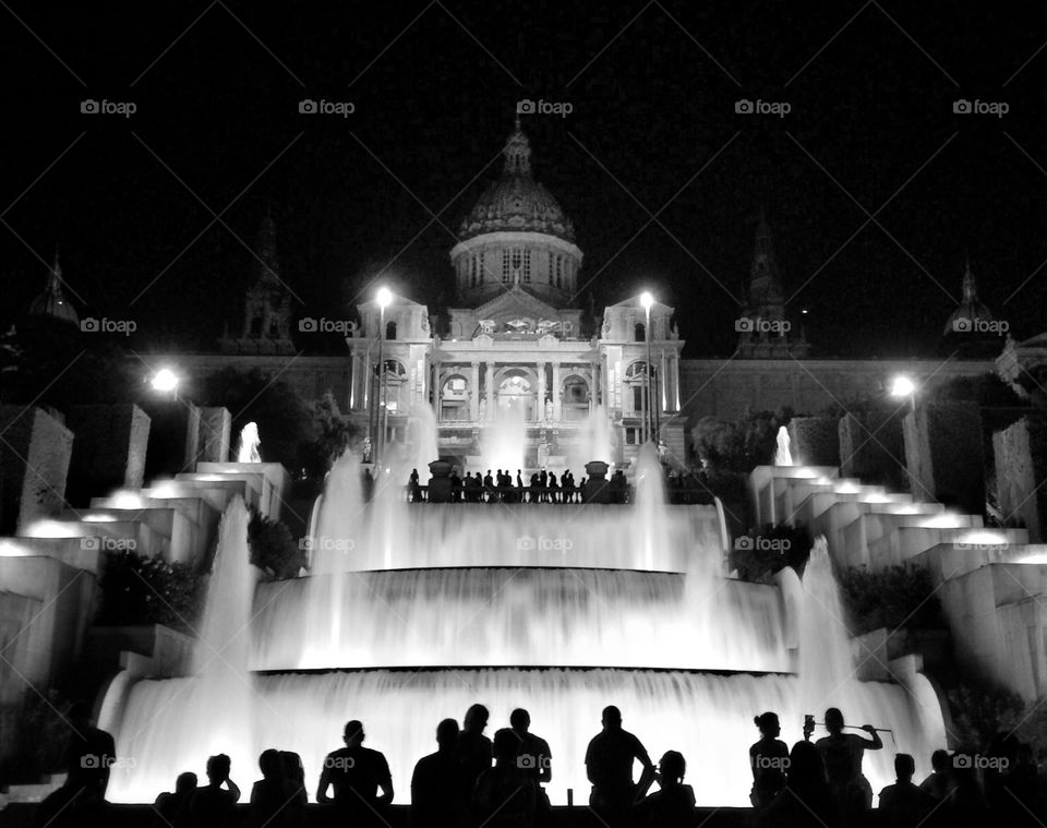 silhouettes in magic fountain . silhouettes of people near the magic fountain of montjuïc in barcelone 