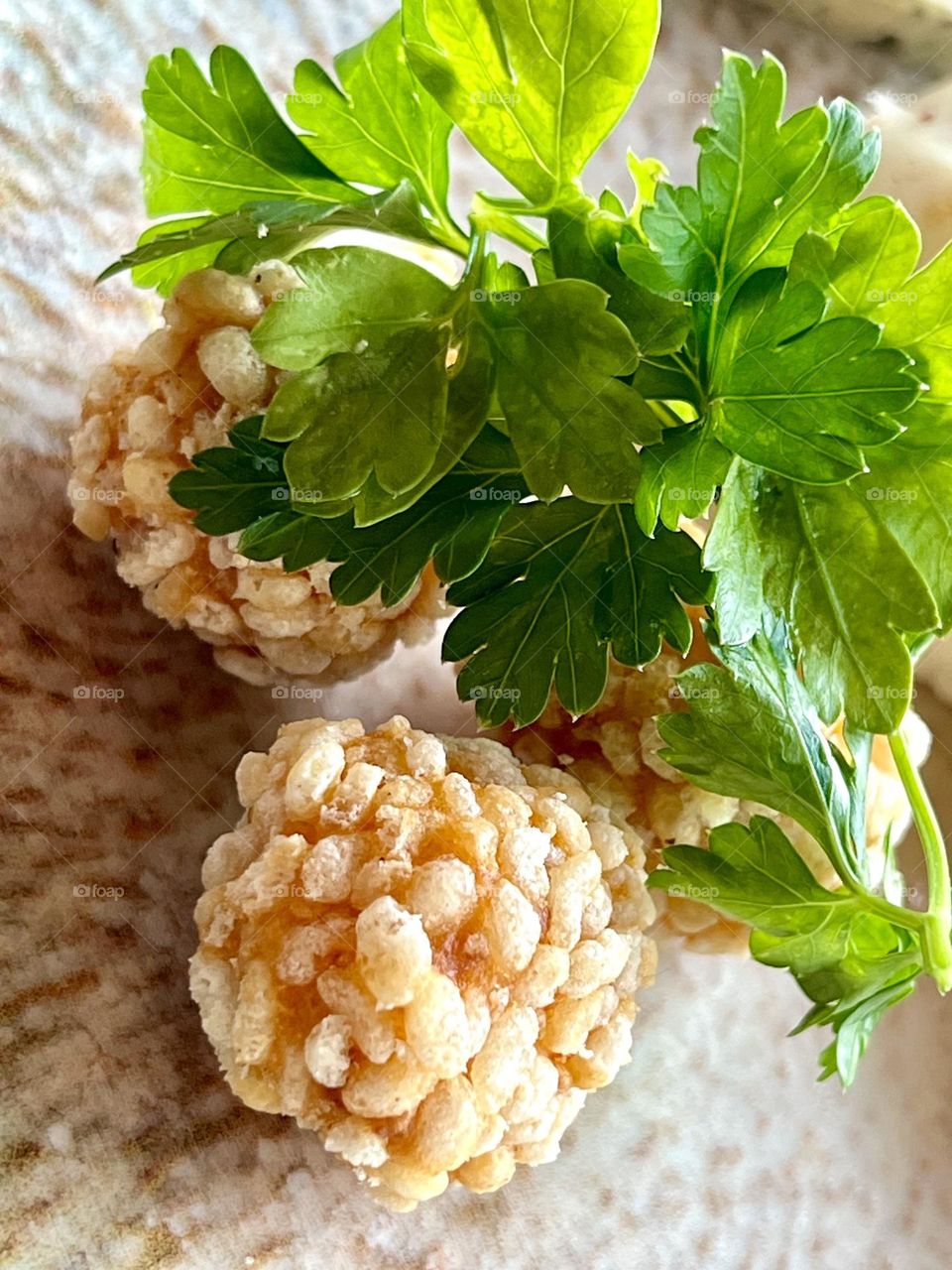 Chicken and rice balls, garnished with a sprig of parsley