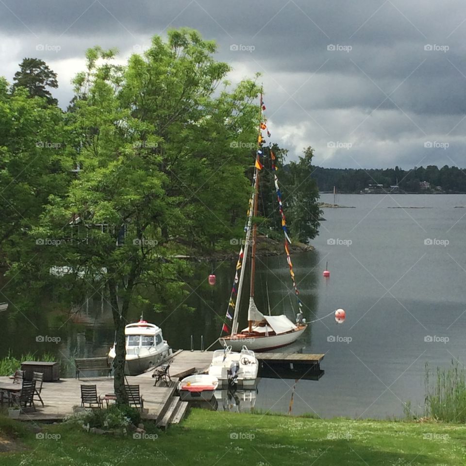 A wooden sailboat in Stockholm. Our wooden sailboat Cobra, Nordic cruiser 5 1/2, at the pier in the archipelago of Stockholm. 