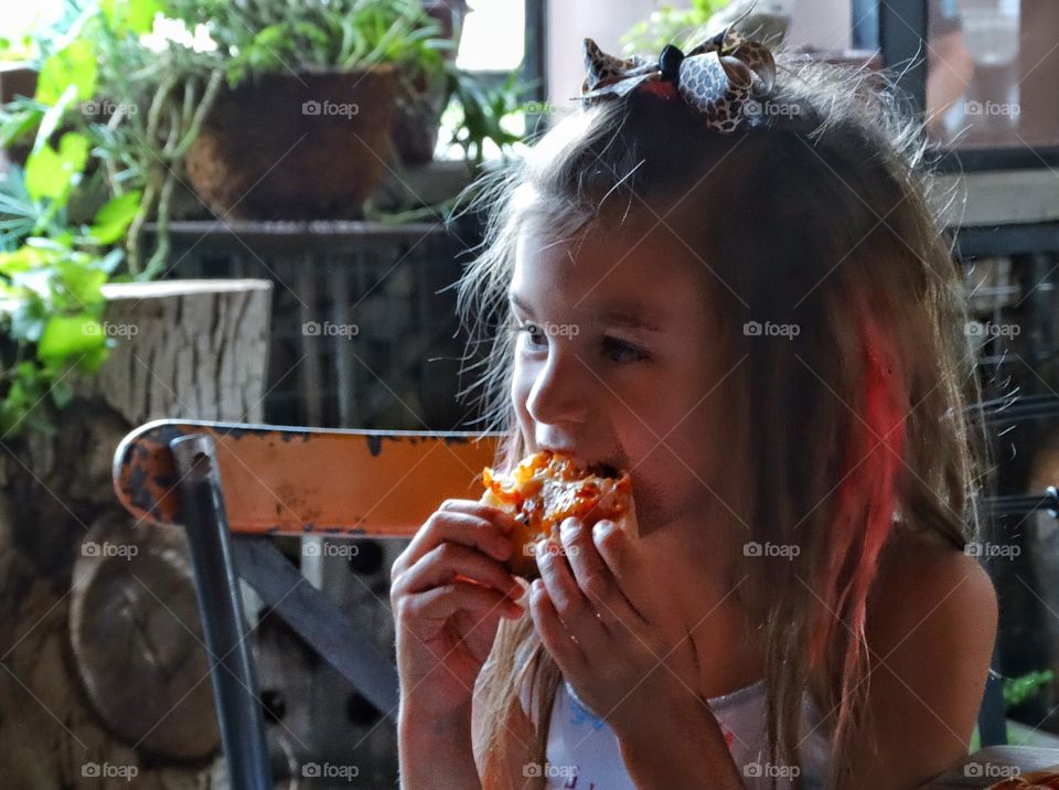 Young Girl Eating Pizza. Young Girl Eating Pizza

