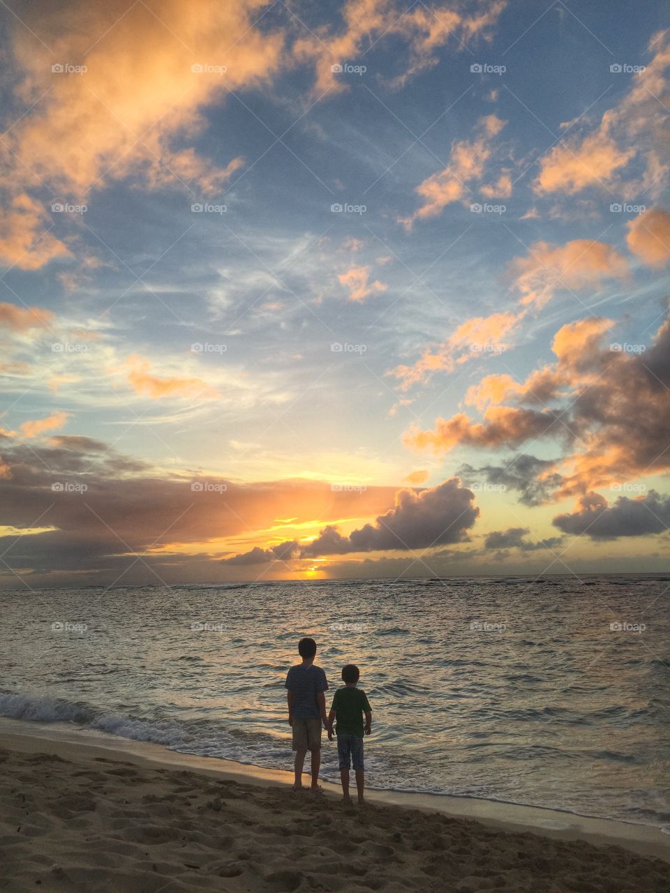 My boys watching the sun go down (and turtles playing in the water!), Oahu