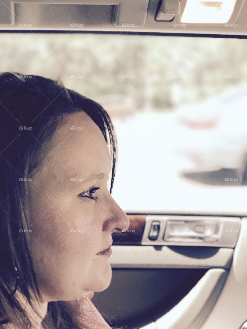 Side view of a woman travelling in car