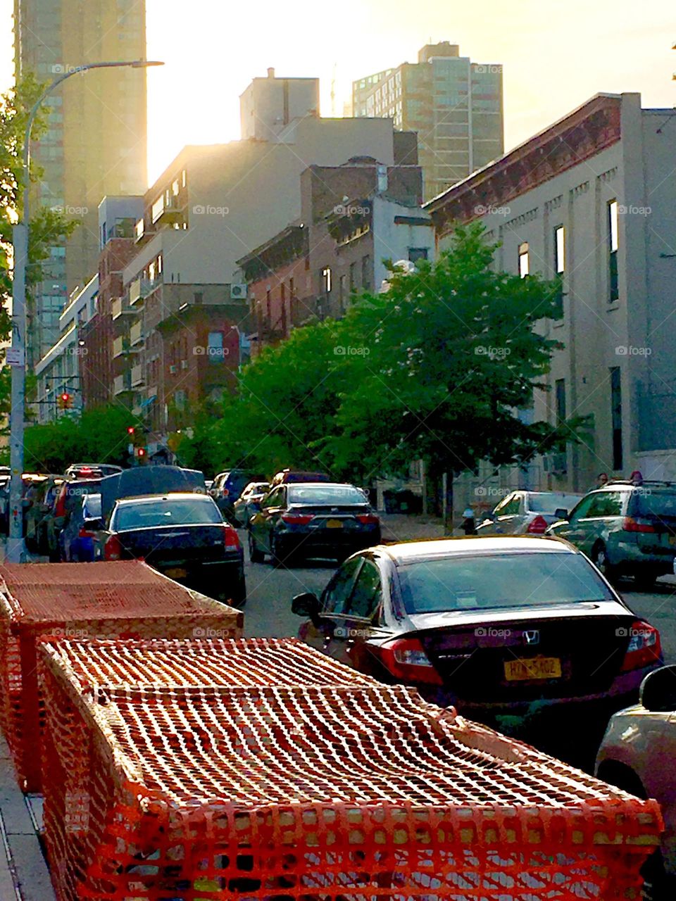 A close view at 48th St in LIC, Queens, NY on a late afternoon in the Spring of 2020. As the sun is setting it spreads its golden glow over everything reflecting especially strong off all things glass and off metallic surfaces. Hypnotic Productions