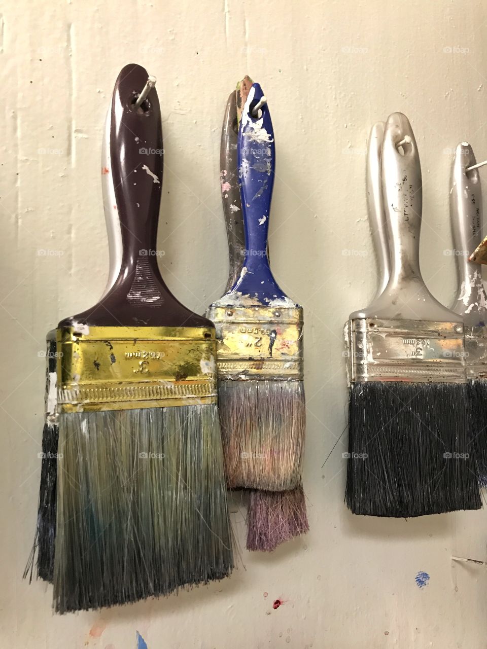 Paint brushes hanging in art room