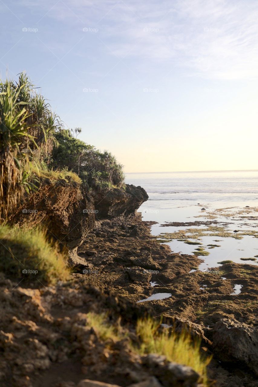 Beautiful sunrise on cliffs overlooking the beaches and oceans of Nusa Dua, Bali, Indonesia. 