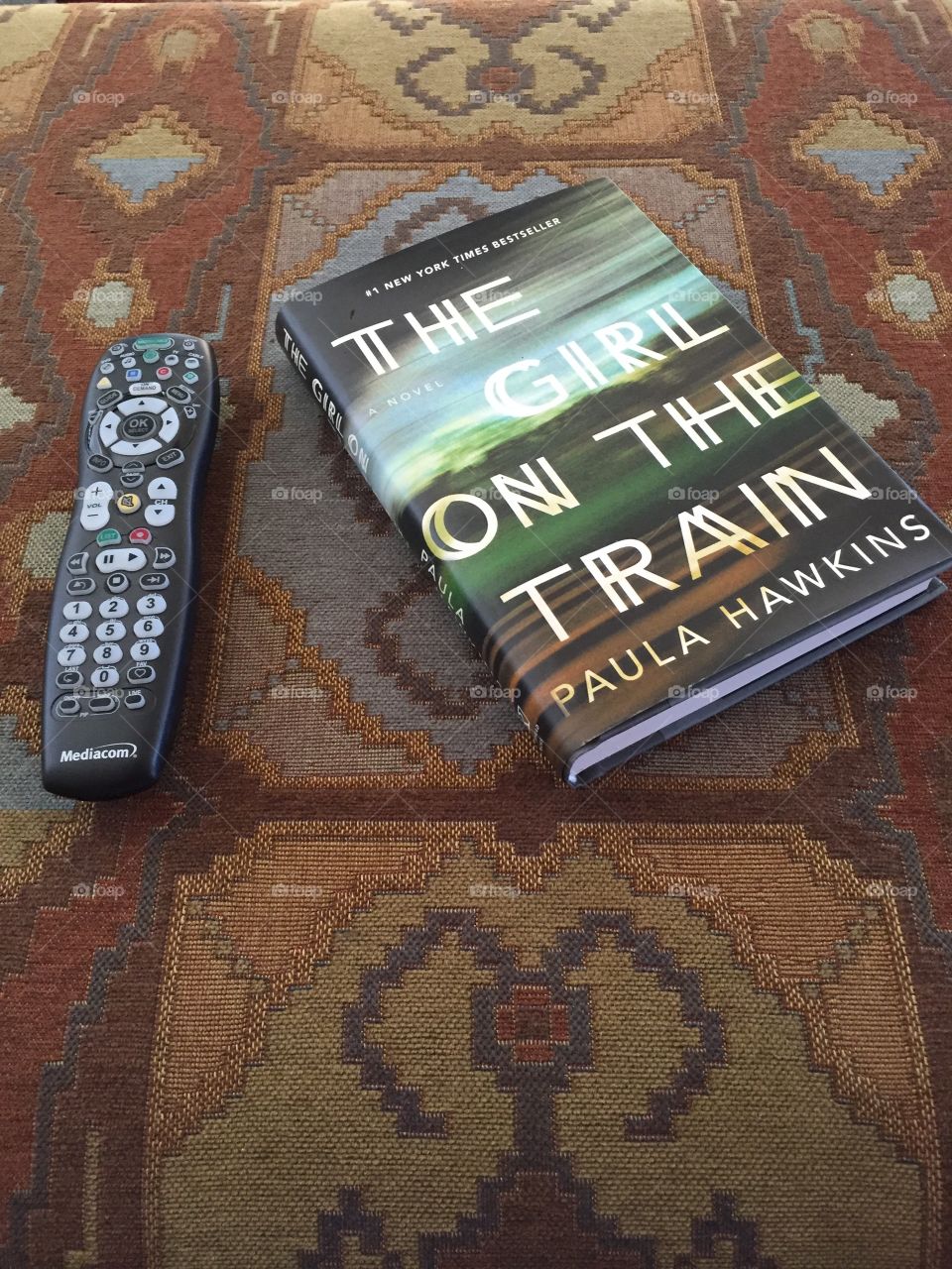 A book and television remote 