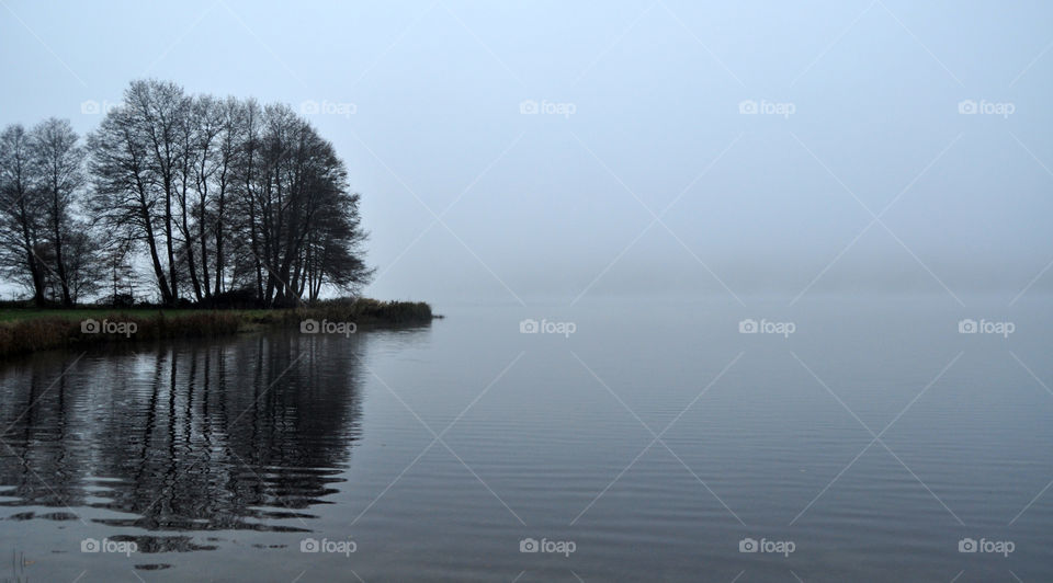 foggy evening on the lake in polish countryside