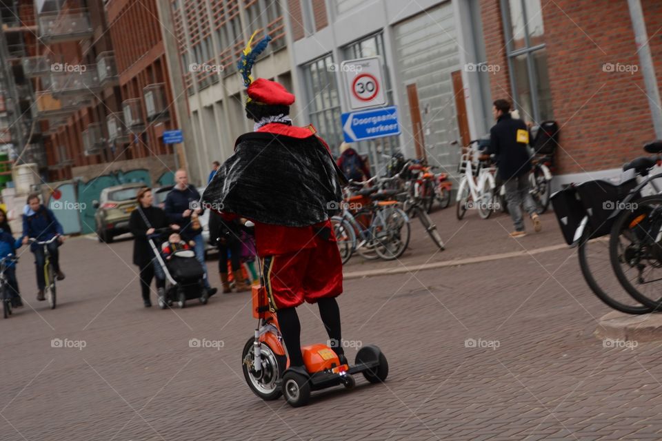 Black Piet driving on the street on a Segway in Scheveningen during the welcoming of Sinterklaas
Zwarte piet rijd op een Segway in Scheveningen tijdens het binnenhalen van Sinterklaas