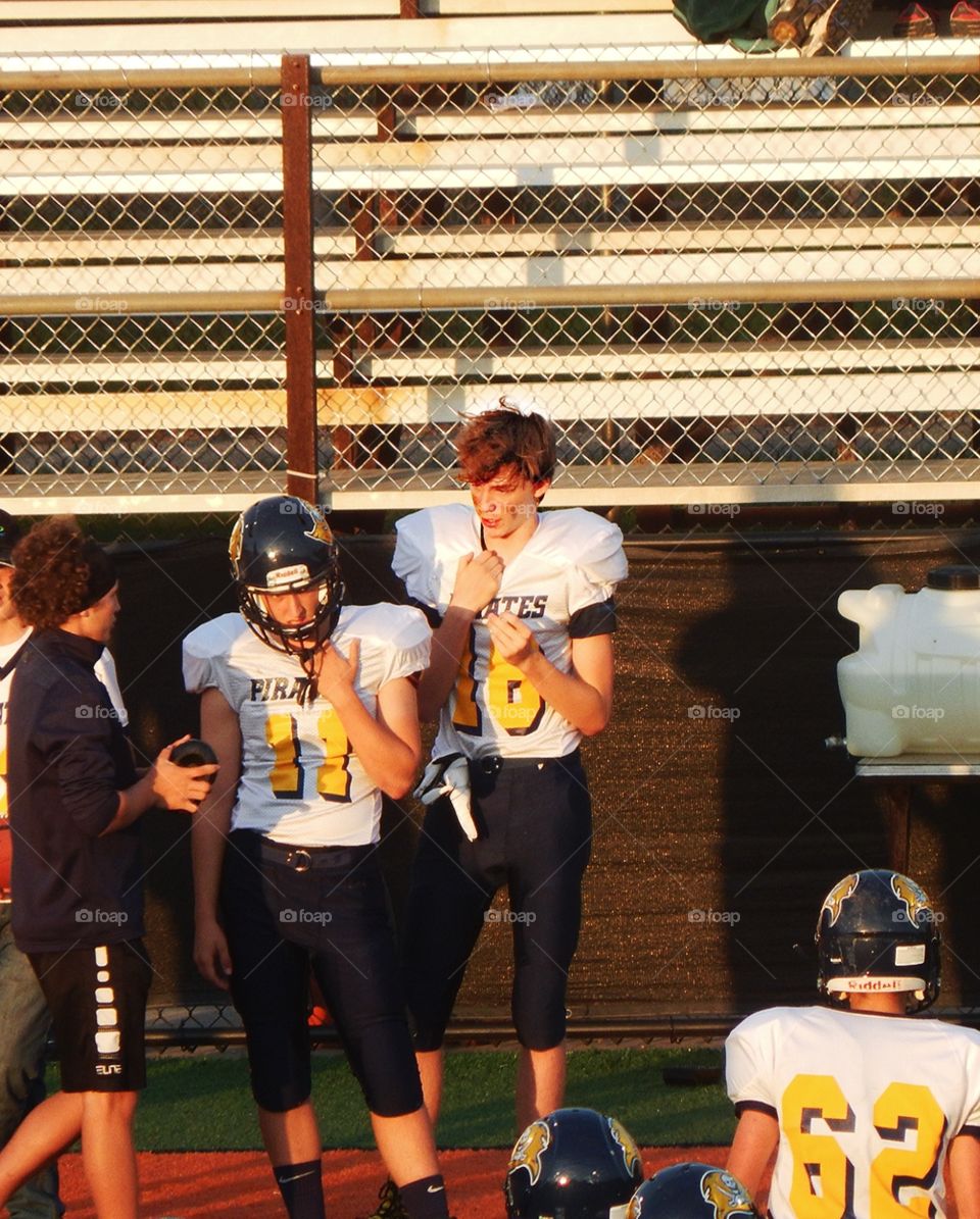 highschool football players on the side line