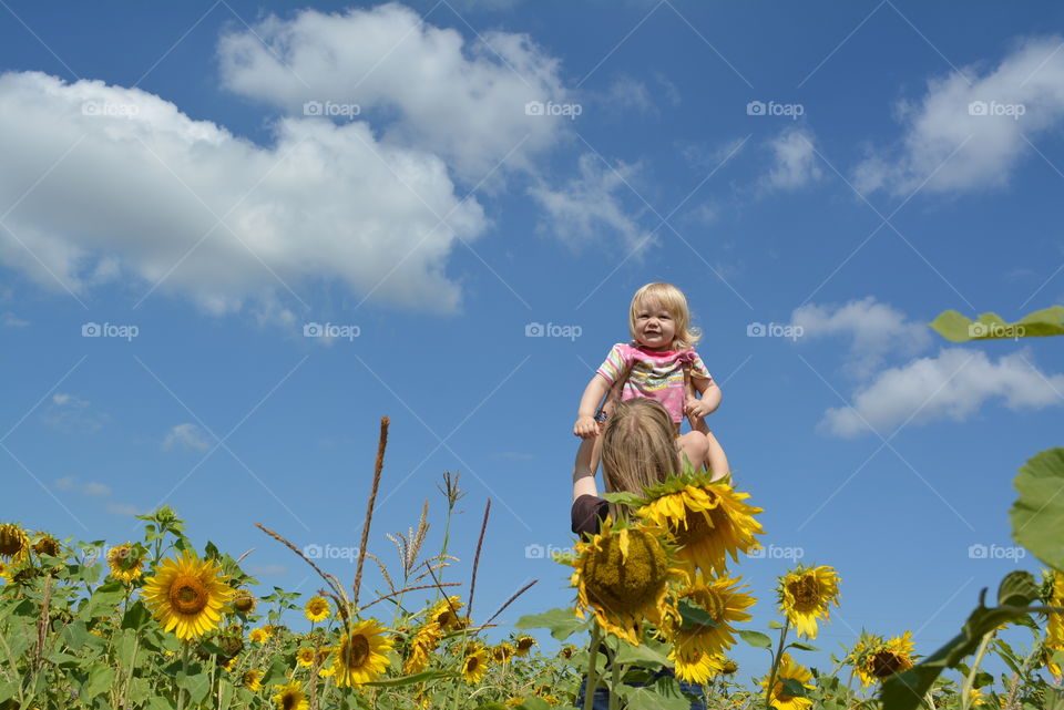 Mother and baby in sunflowers
