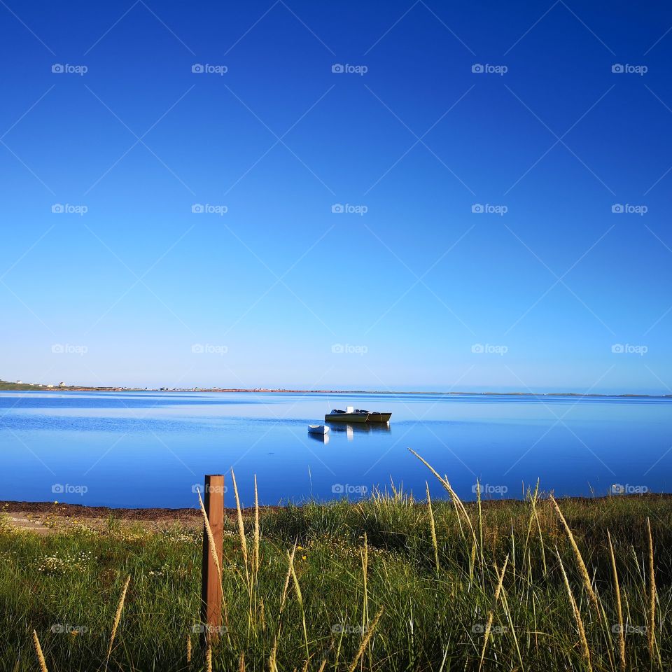 Boats in a peaceful lagoon. Îles-de-la-Madeleine, Québec, Canada.